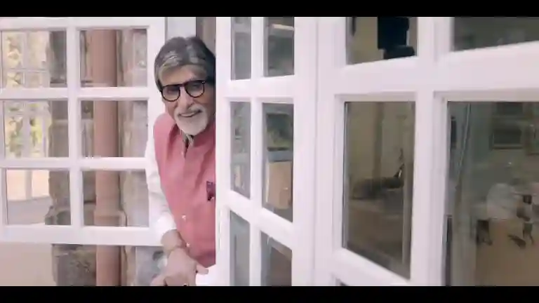 Amitabh Bachchan addressing the camera with a grave expression during the polio immunization campaign, village road visible behind him