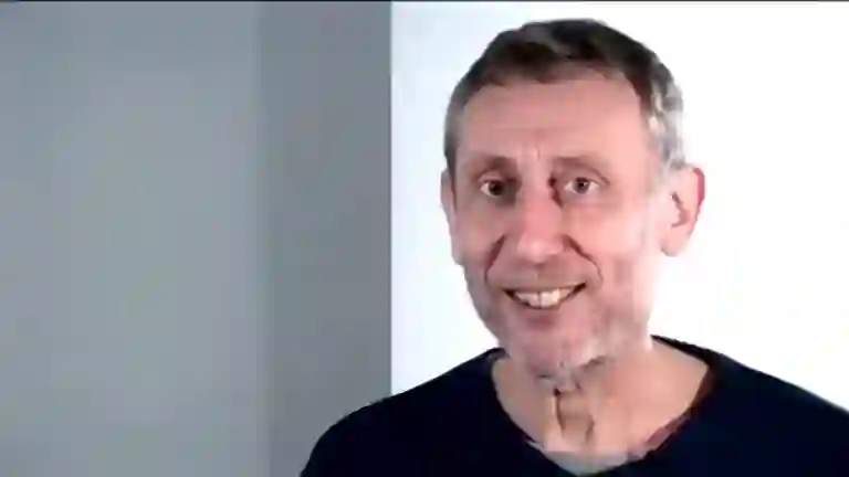 Michael Rosen looking at camera with a gentle smirk after saying Nice in 2008 video