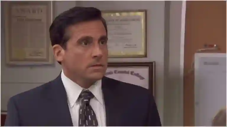 Michael Scott with both hands covering his face, head tilted back in horrified disbelief, from The Office Season 5 Episode 9