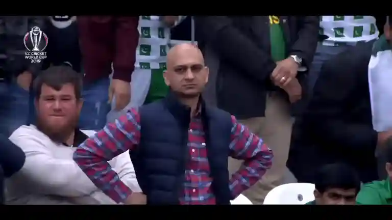 Muhammad Sarim Akhtar standing among the crowd with both hands on his hips, staring ahead in disappointment after a dropped catch at the 2019 World Cup match