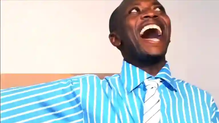 Kwadwo Nkansah looking upward with a wide smile and eyes open in the Oh My God Wow meme scene from Azonto Ghost