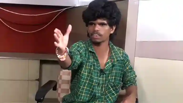 Rakesh Master laughing after shoving his friend, the moment of playful energy from the Telugu interview